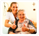 caregiver and elder showing thumbs up